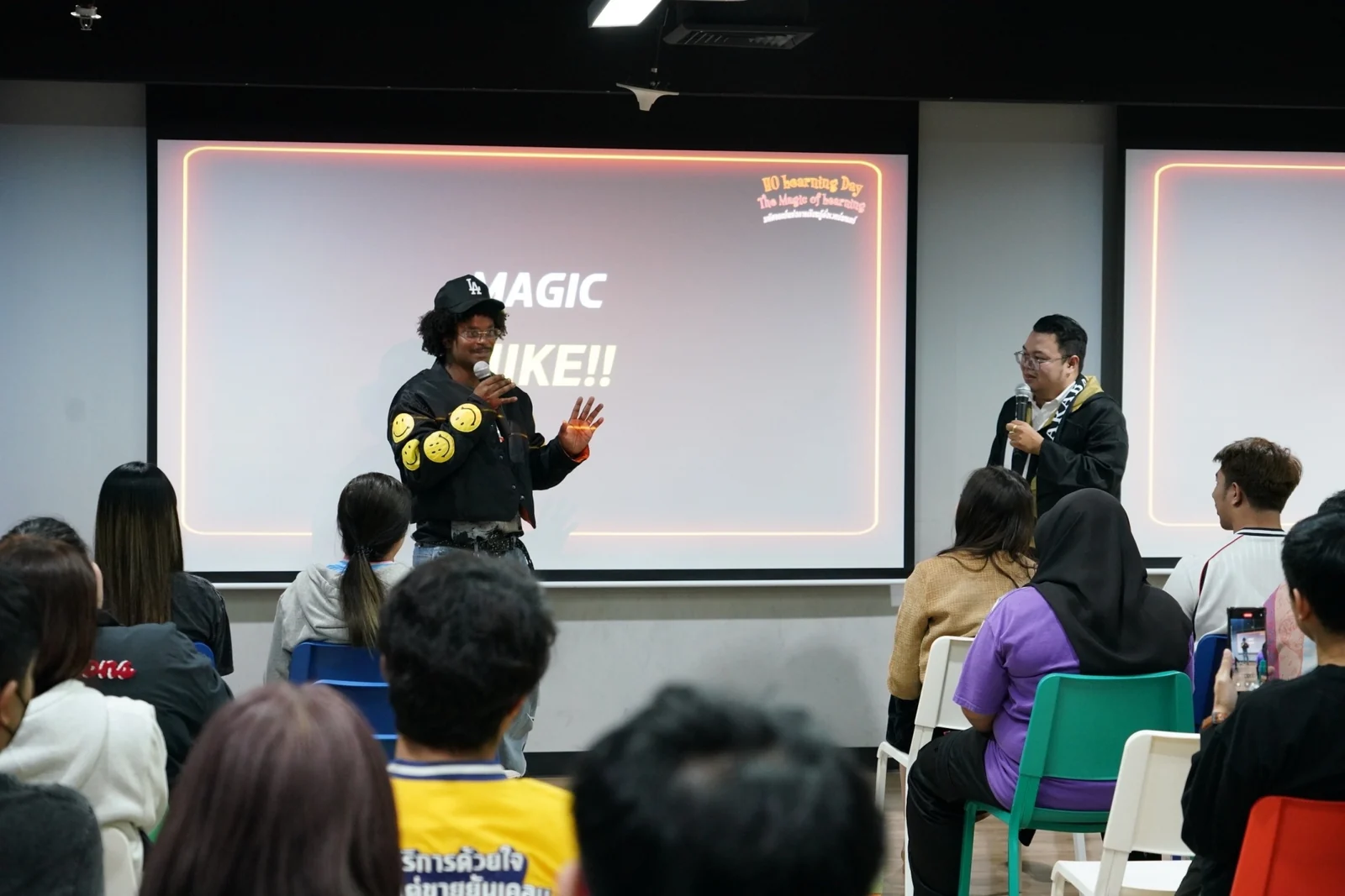 Speaking to an audience at a Learning Day event.