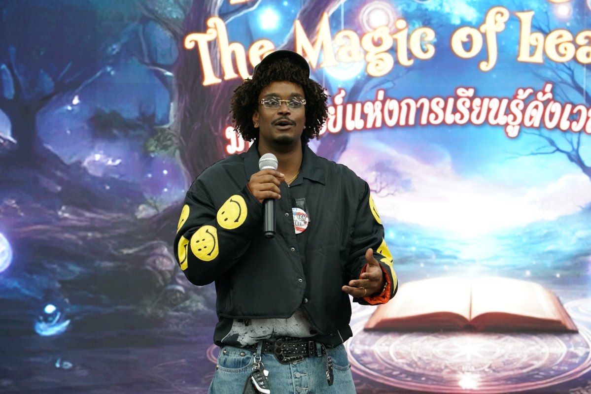 Teacher Mike presenting with a microphone at a learning event